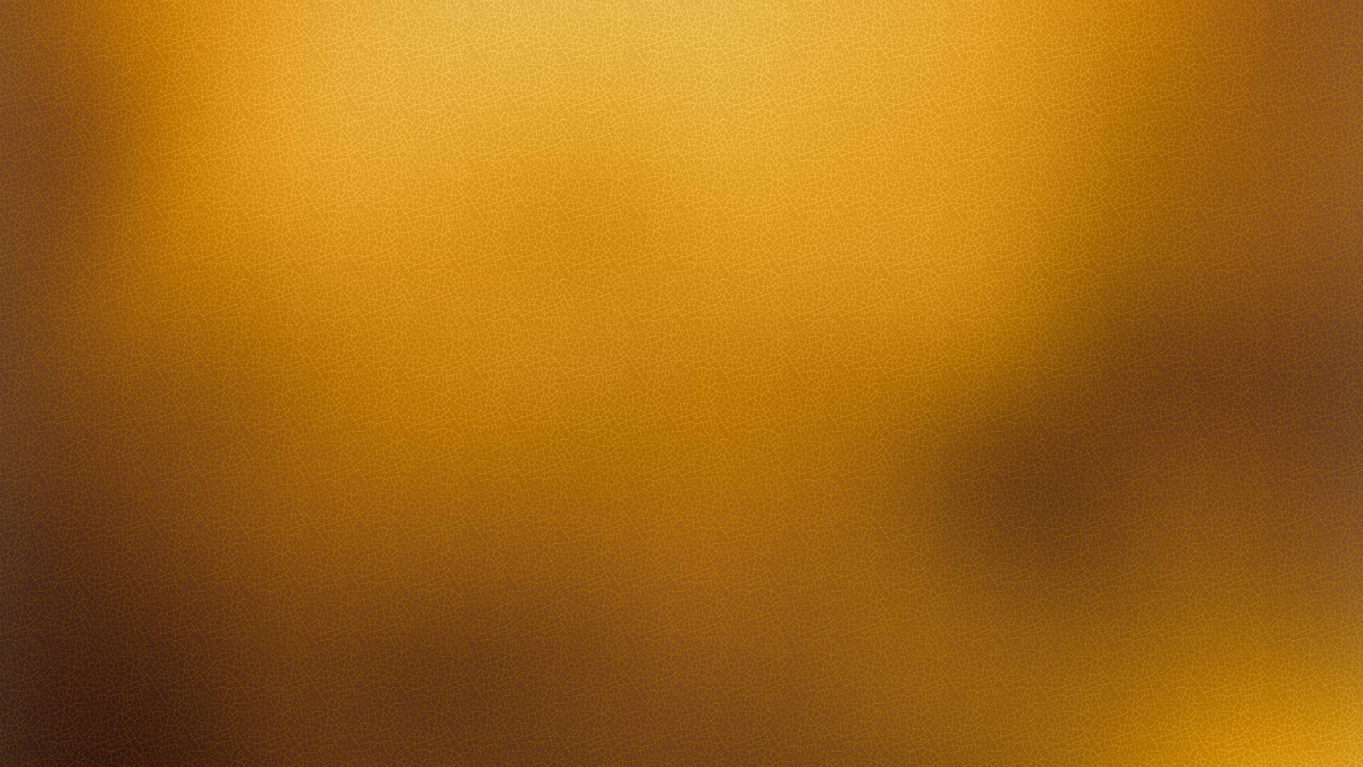 Gold Texture 桌布 壁紙 — 溫暖金色琥珀色調的柔和漸變，帶有細微紋理和模糊邊緣，營造出寧靜的抽象背景。