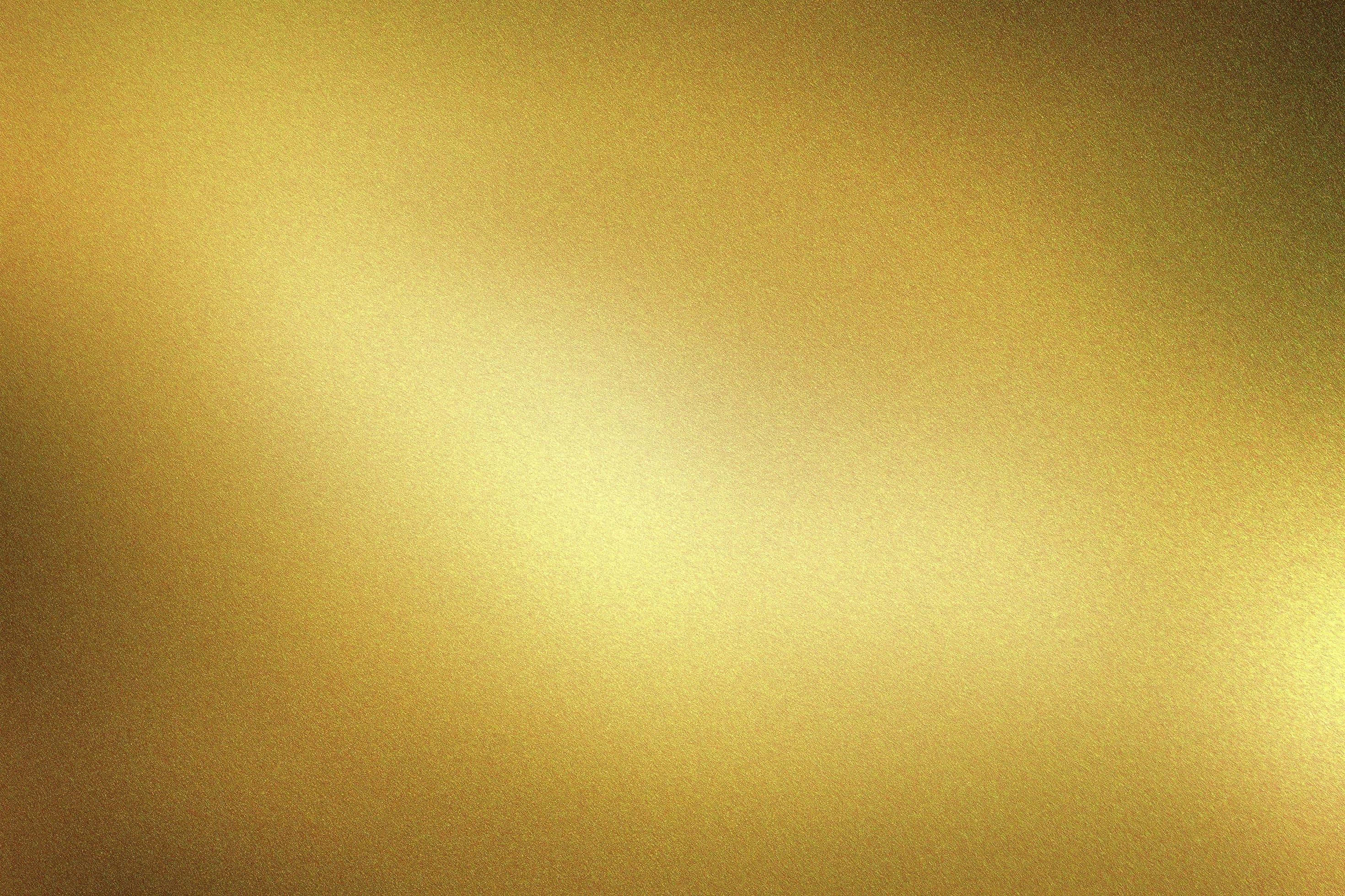 Gold Texture 桌布 壁紙 — 溫暖金色色調的平滑漸變，表面帶有細微紋理和柔和的光線變化。
