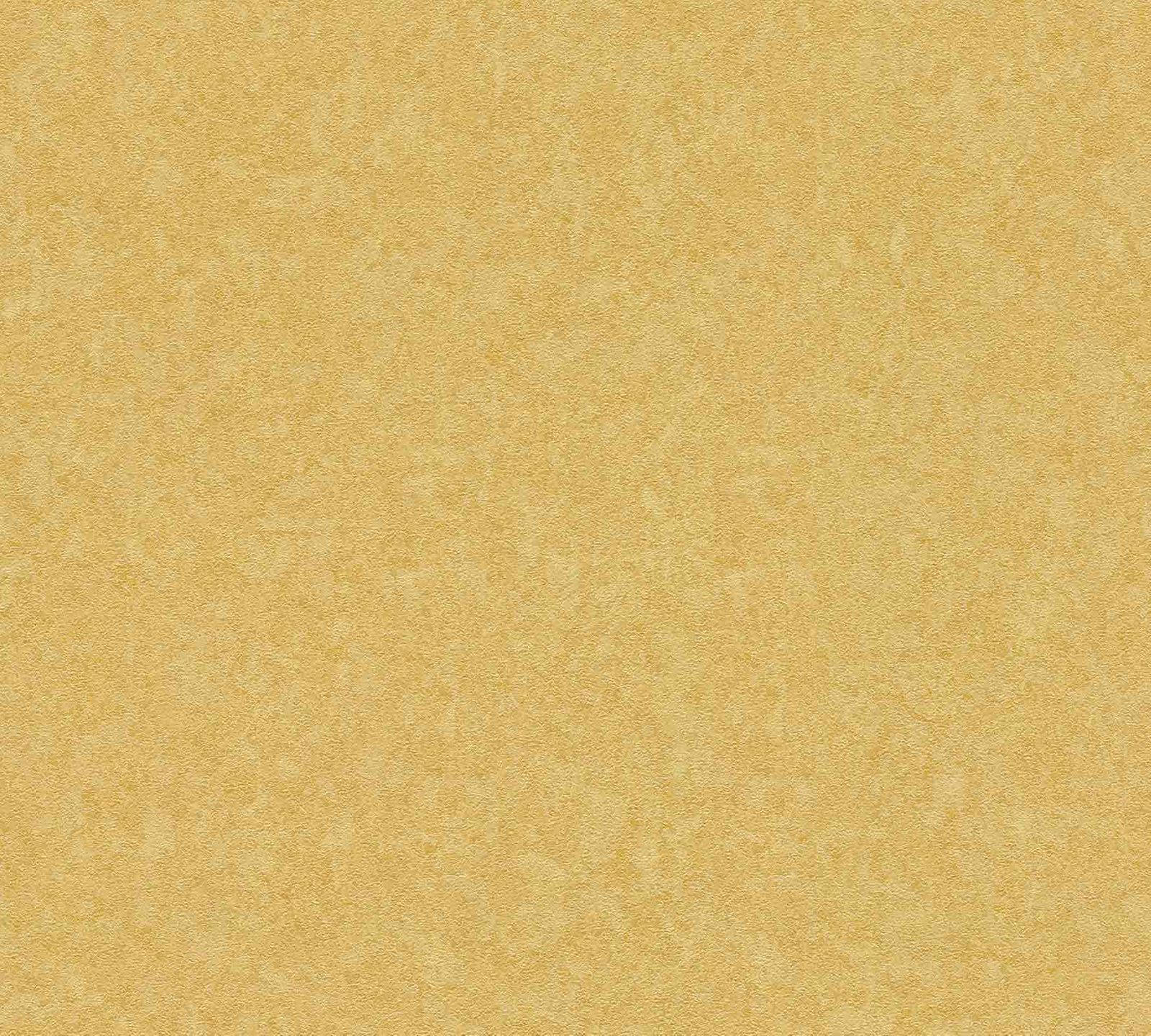 Gold Abstract 桌布 壁紙 — 溫暖金黃色紋理表面的特寫，帶有細微的斑駁圖案和柔和顆粒細節。