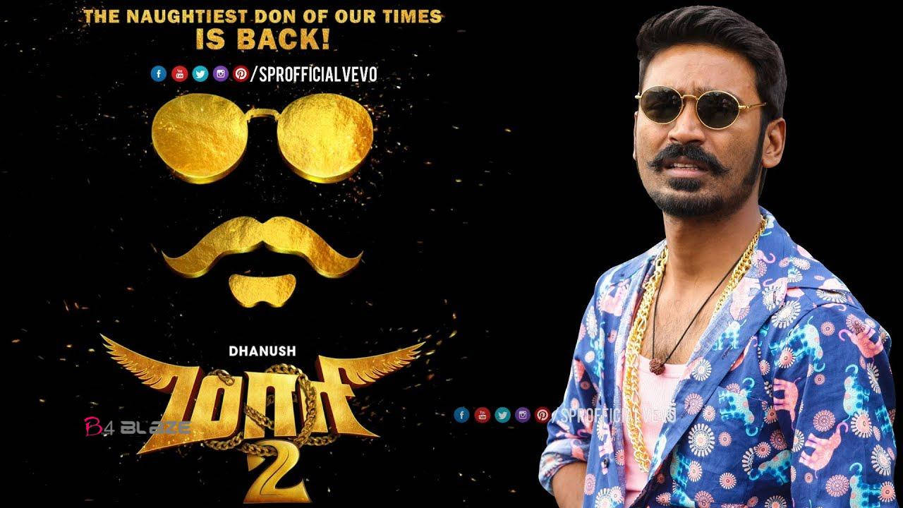 Bollywood HD 桌布 壁紙 — 演員Dhanush身穿彩色圖案外套和金色太陽眼鏡，在電影《Zoon 2》的金色風格化臉部標誌旁擺姿勢。