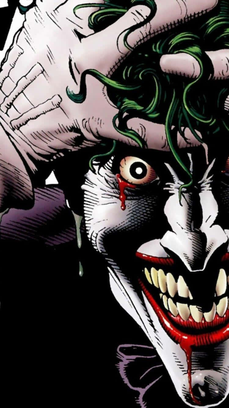 The Joker Comic 桌布 壁紙 — 漫畫書特寫小丑，綠色頭髮，血從他的眼睛和嘴巴滴落，他痛苦地抓著頭。