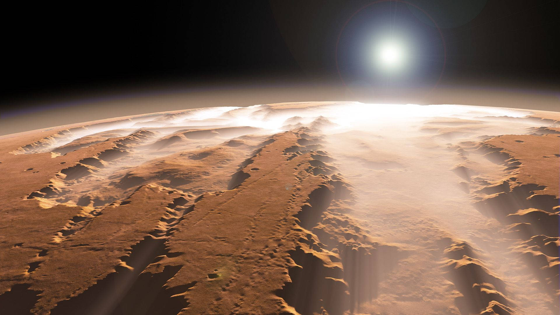 火星 桌布 壁紙 — 火星崎嶇、鏽色表面沐浴在金色陽光和大氣薄霧中的壯麗景色。