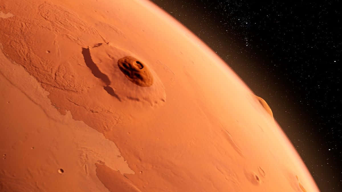 Mars Planet 桌布 壁紙 — 火星的特寫視圖，展示其生鏽的橙色表面，有一個突出的隕石坑，背景是佈滿星星的黑色天空。