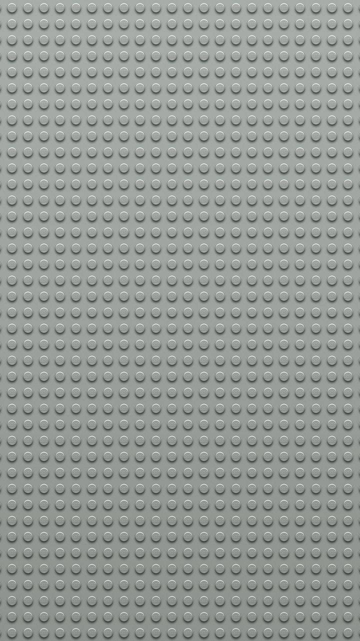 樂高 桌布 壁紙 — 灰色LEGO底板的特寫，表面覆蓋均勻的圓形凸點網格。