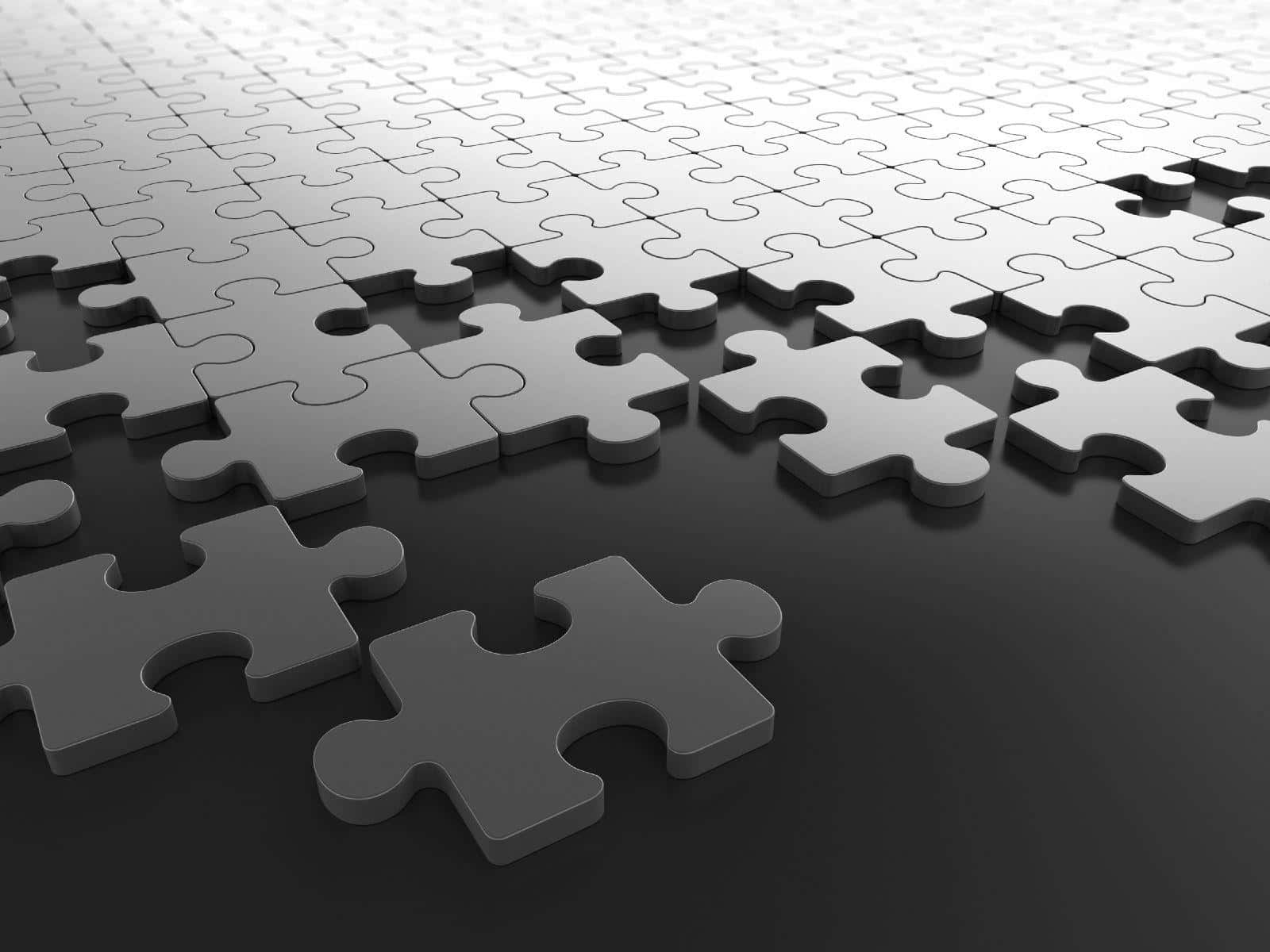 Puzzle 桌布 壁紙 — 灰色拼圖塊以對角線圖案排列在深色表面上，帶有柔和陰影的特寫。