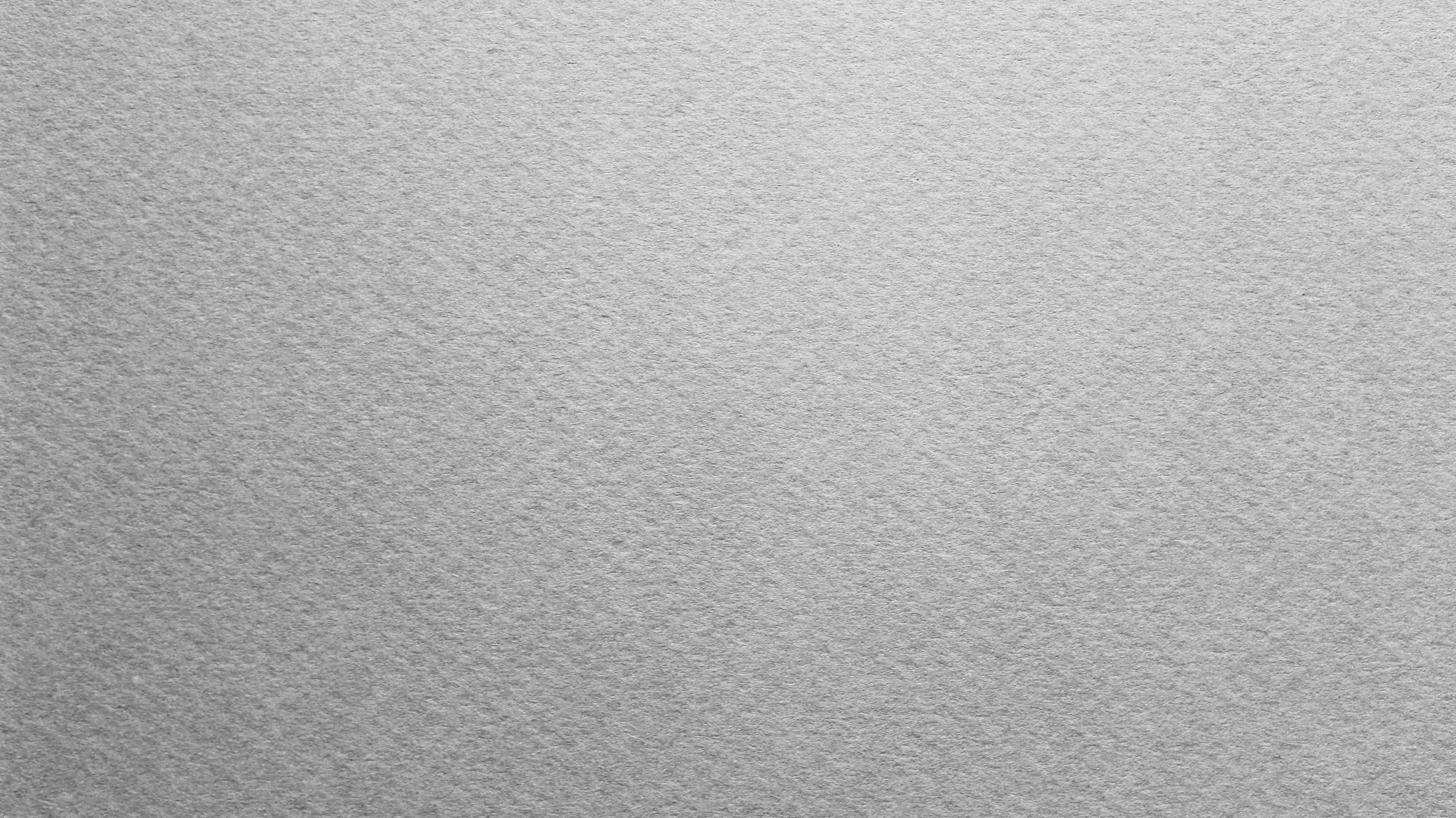 Textured 桌布 壁紙 — 灰色紋理紙張表面的特寫，帶有微妙的色調變化和細微紋理。