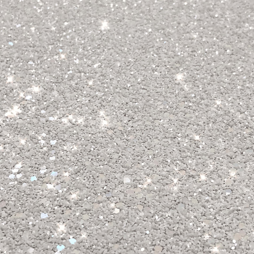 Surface 桌布 壁紙 — 灰色紋理表面的特寫，點綴著閃閃發光的白色和淺藍色亮粉顆粒。
