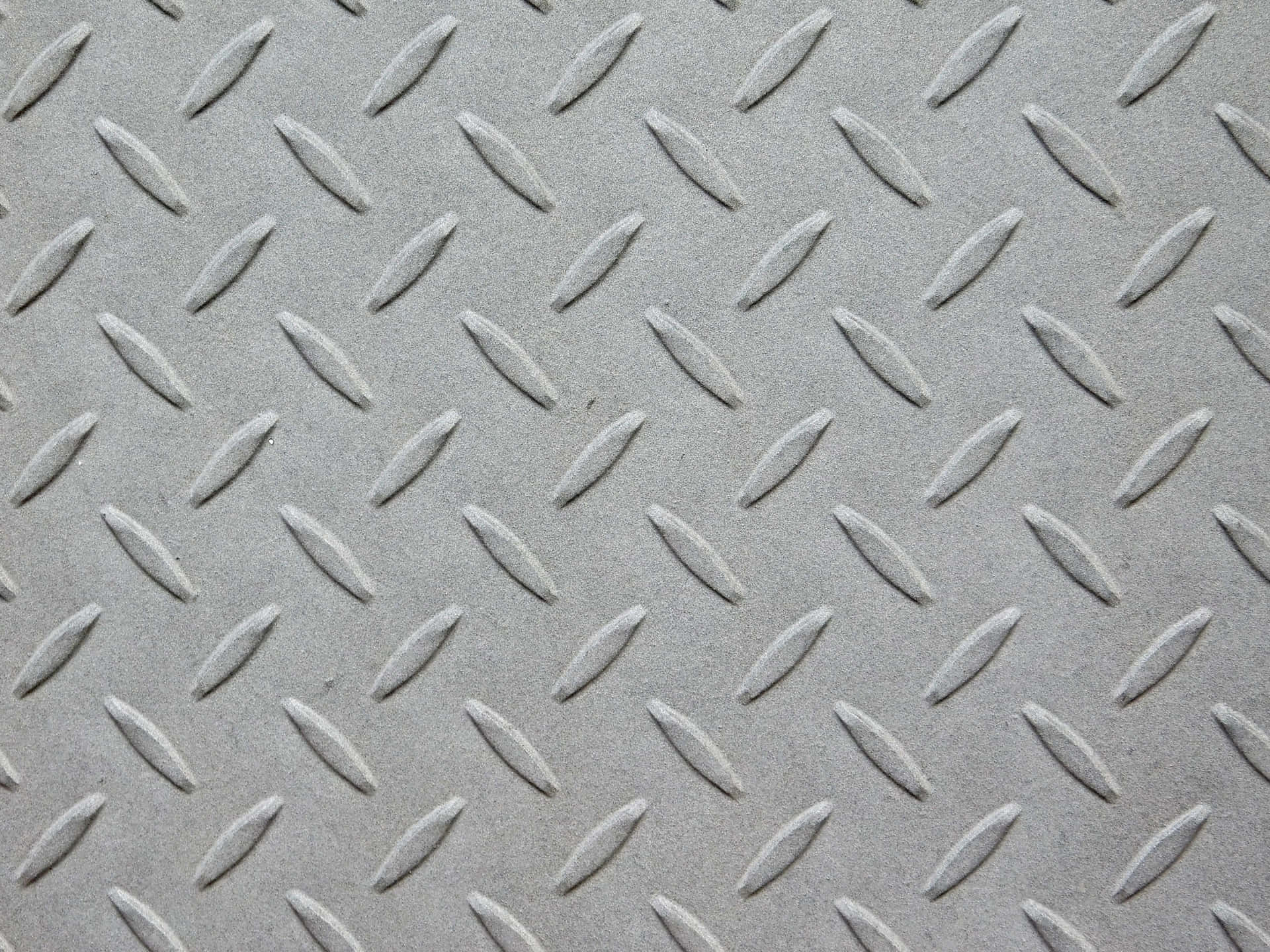 Metal texture 壁紙 — 灰色菱形金屬板紋理特寫，帶有凸起的菱形圖案和微妙的陰影。