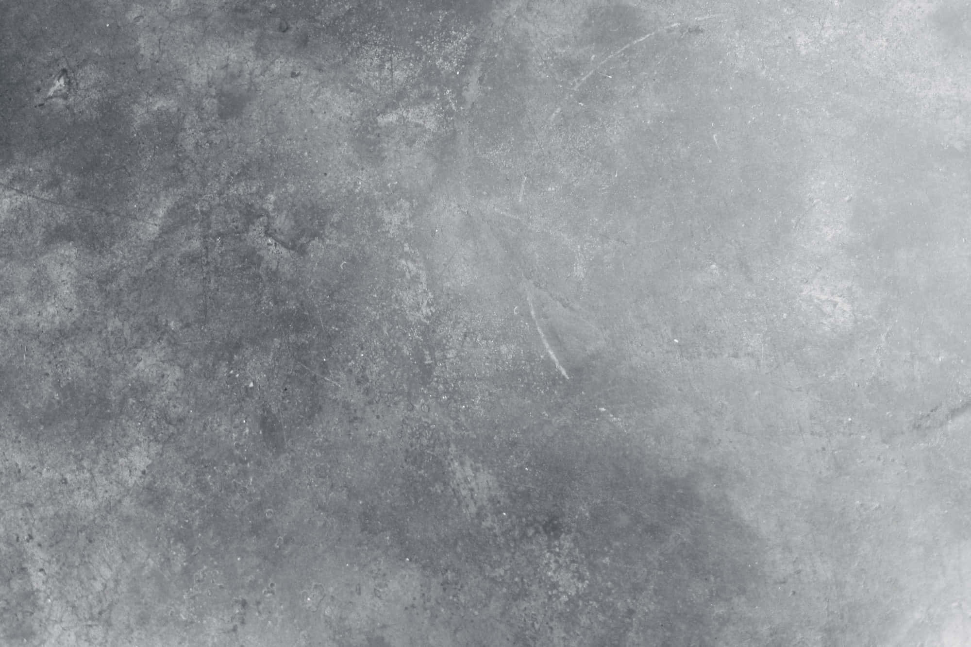 Grey Texture 桌布 壁紙 — 灰色風化混凝土表面的特寫，帶有細微紋理和輕微刮痕。