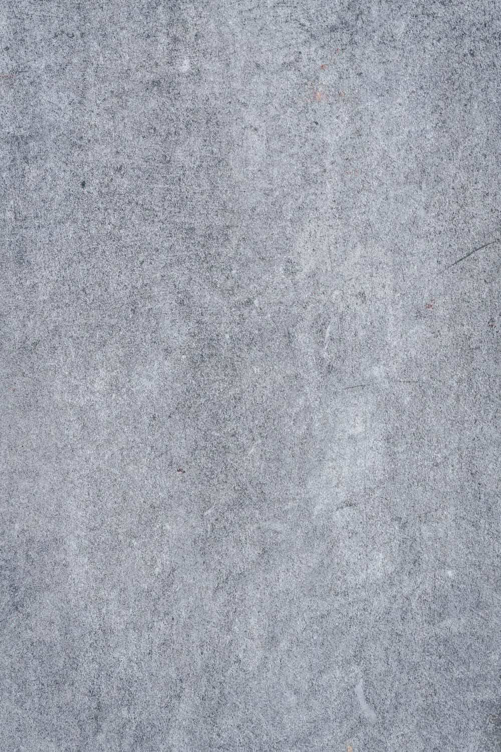 Grey Texture 桌布 壁紙 — 灰色風化混凝土表面的特寫，帶有細微紋理和輕微刮痕。