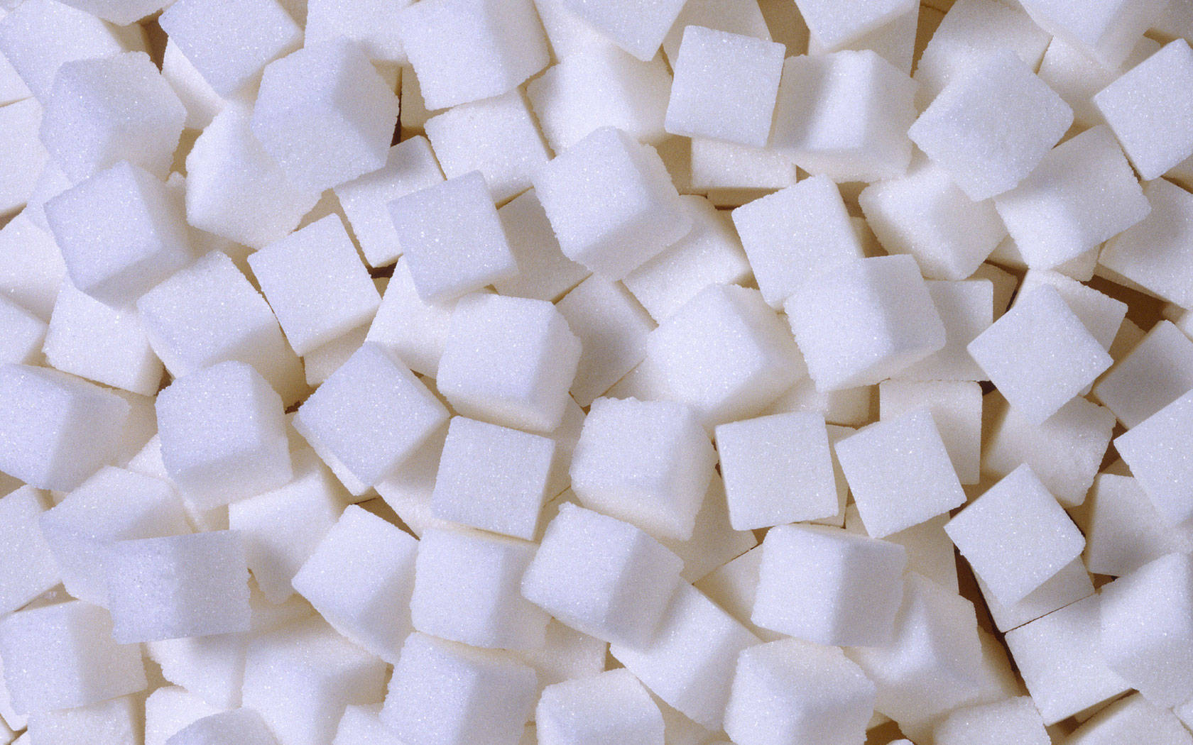 Sugar 桌布 壁紙 — 無數白色方糖堆疊在一起的近距離特寫，帶有柔和陰影和細膩的結晶質感。