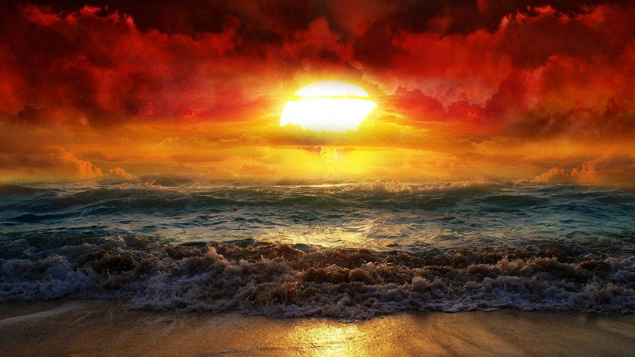 旭日東昇 桌布 壁紙 — 熾熱的夕陽將天空染成紅色和橙色，海浪拍打著沙灘。