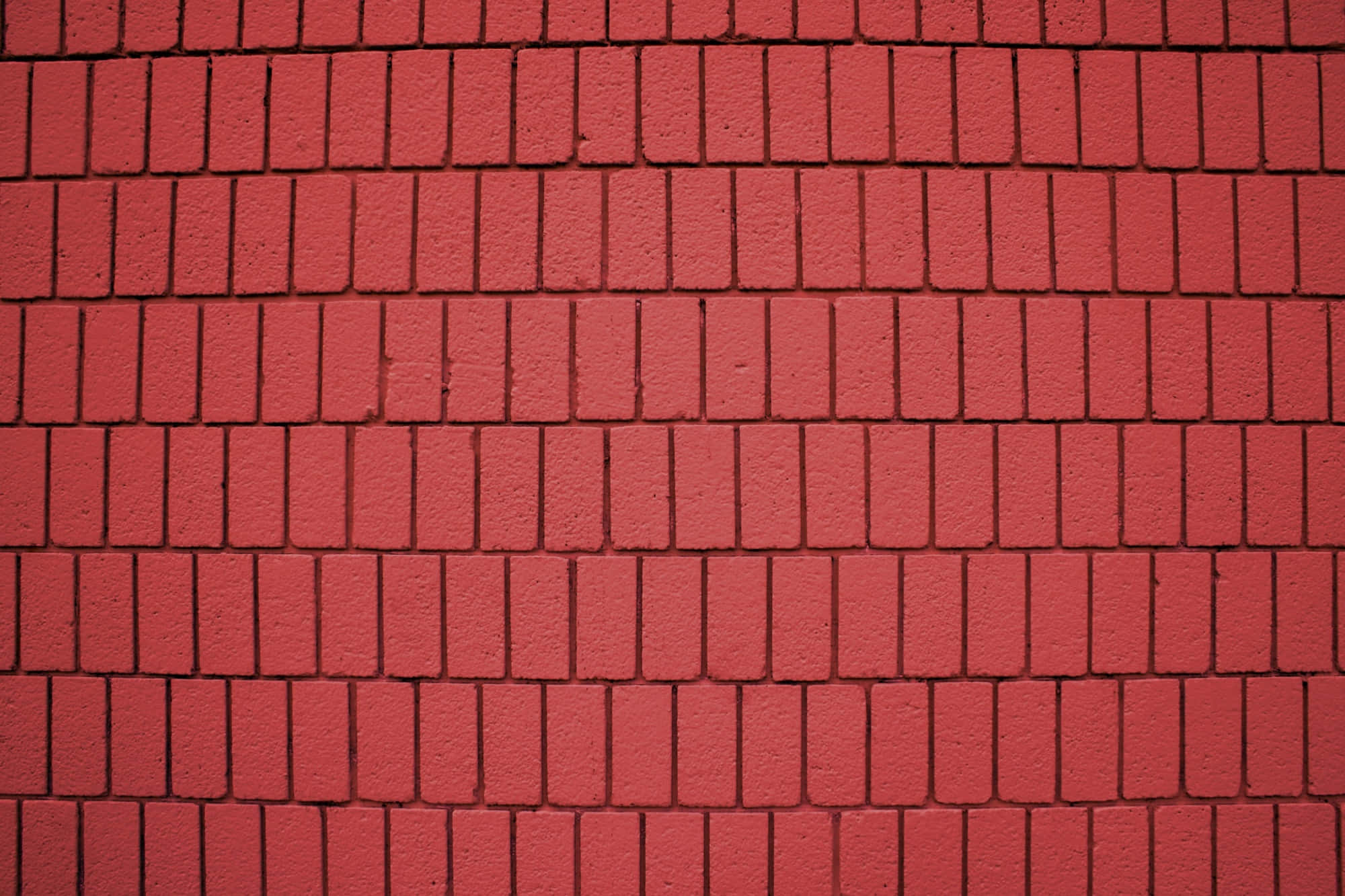 Brick 桌布 壁紙 — 牆壁特寫，覆蓋著均勻的紅色長方形磚塊，排列成整齊的水平行。