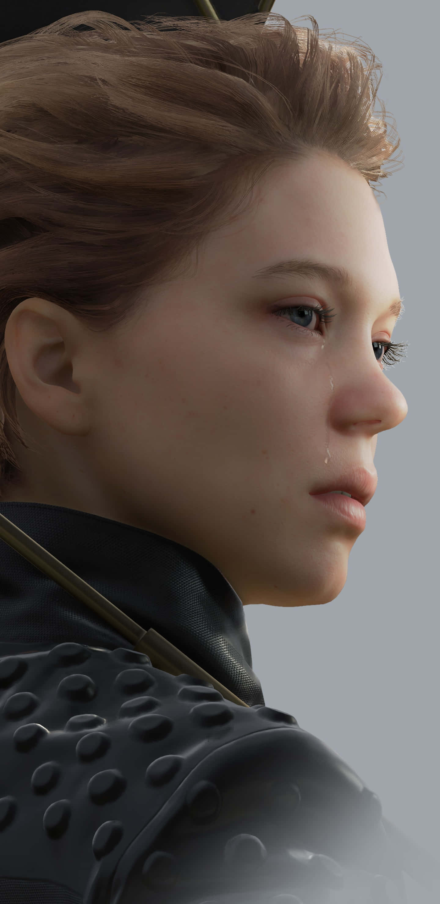 Death Stranding Mobile 桌布 壁紙 — 特寫一位身穿深色盔甲的女性，淚水順著臉頰滑落，背景為柔和的灰色。