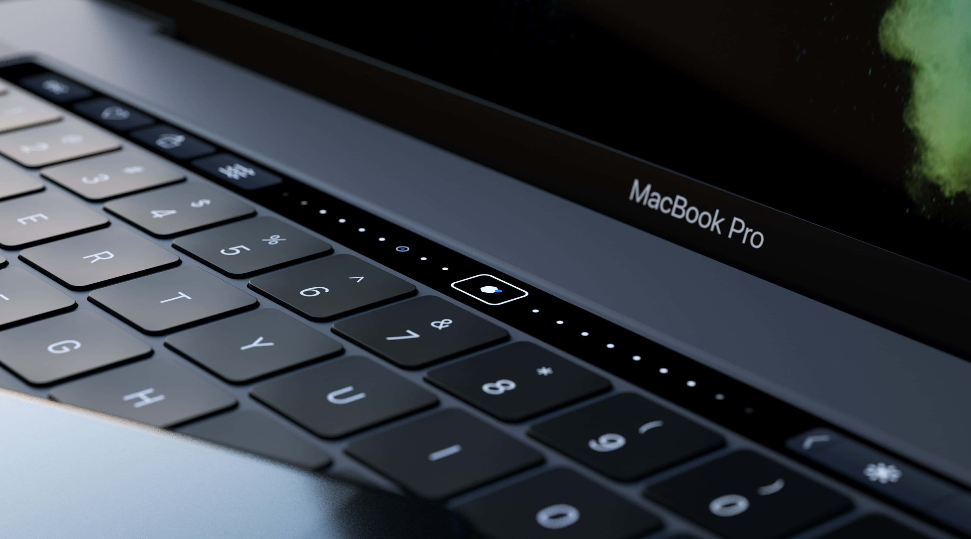 美學 MacBook 壁紙 桌布 壁紙 — 特寫一個時尚的MacBook Pro鍵盤，帶有發光的觸控板和發光的狀態指示燈，背景為暗色螢幕。