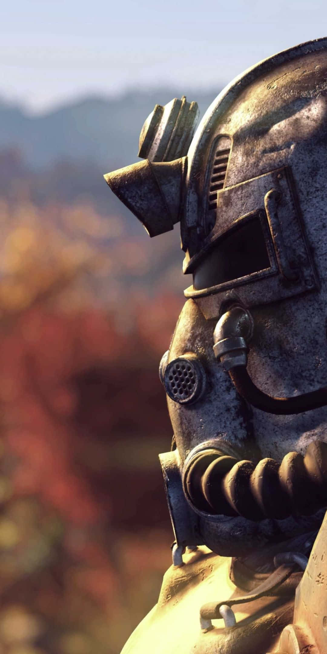 Pixel 3 Fallout 76 桌布 壁紙 — 特寫一個風化的動力裝甲頭盔，背景是模糊的秋日森林。