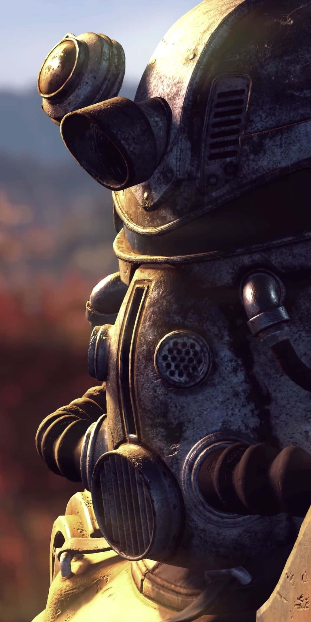 Pixel 3 Fallout 76 桌布 壁紙 — 特寫一個風化的金屬動力裝甲頭盔，帶有發光面罩，背景是朦朧的秋日景色。
