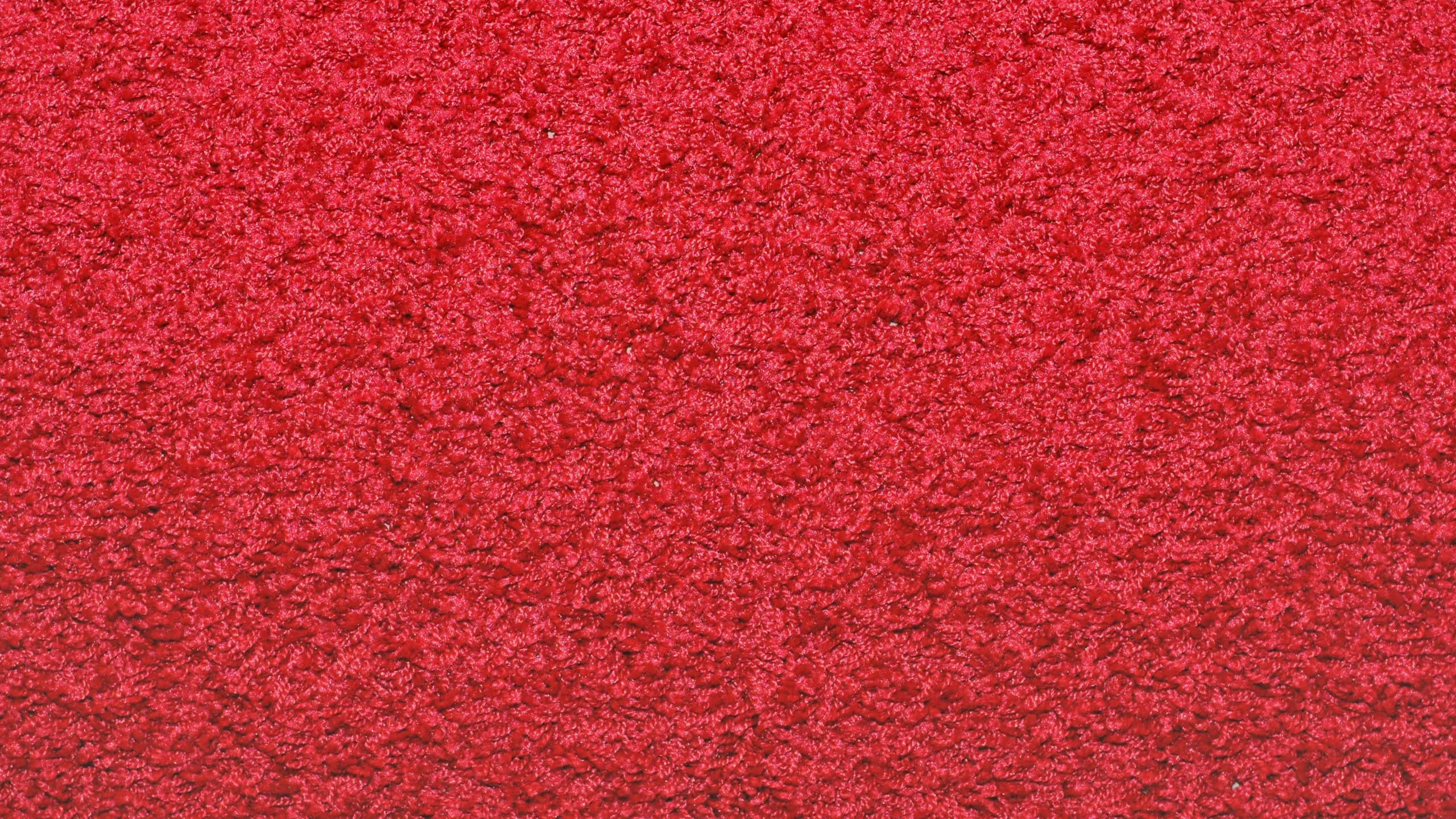 Carpet 桌布 壁紙 — 特寫一張質感豐富的紅色地毯，帶有密集的圈絨圖案。