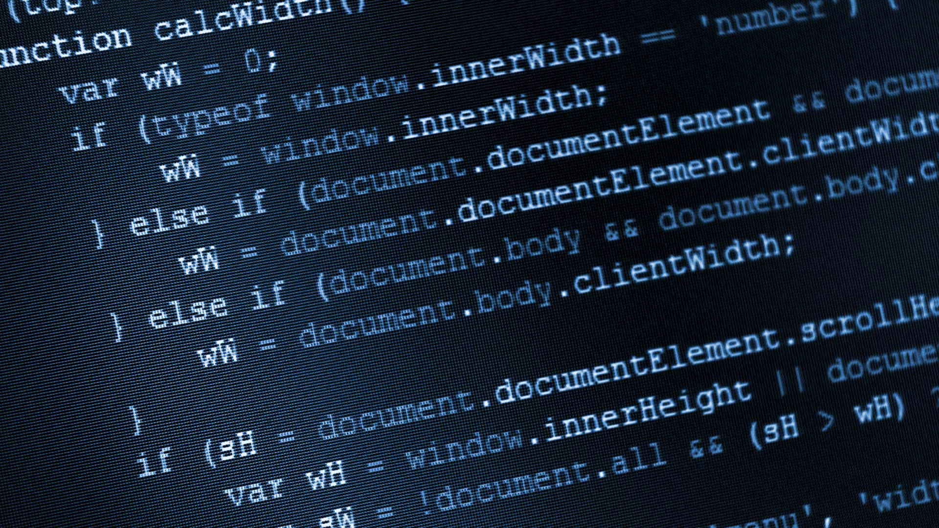 科技動圖 桌布 壁紙 — 特寫發光藍色JavaScript程式碼在深色電腦顯示器螢幕上滾動。