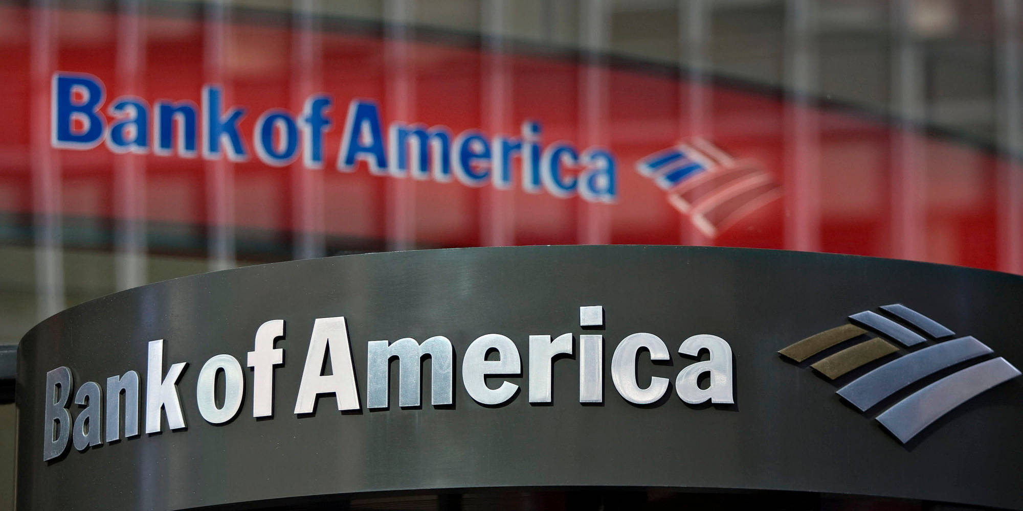 Bank 桌布 壁紙 — 特寫鏡頭：一個時尚的 Bank of America 標誌，帶有金屬字體和標誌，背景為模糊的紅色。