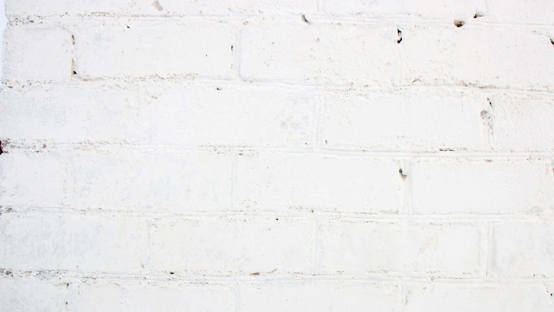 White Brick 桌布 壁紙 — 特寫鏡頭：風化白色磚牆，可見砂漿線條和細微紋理瑕疵。