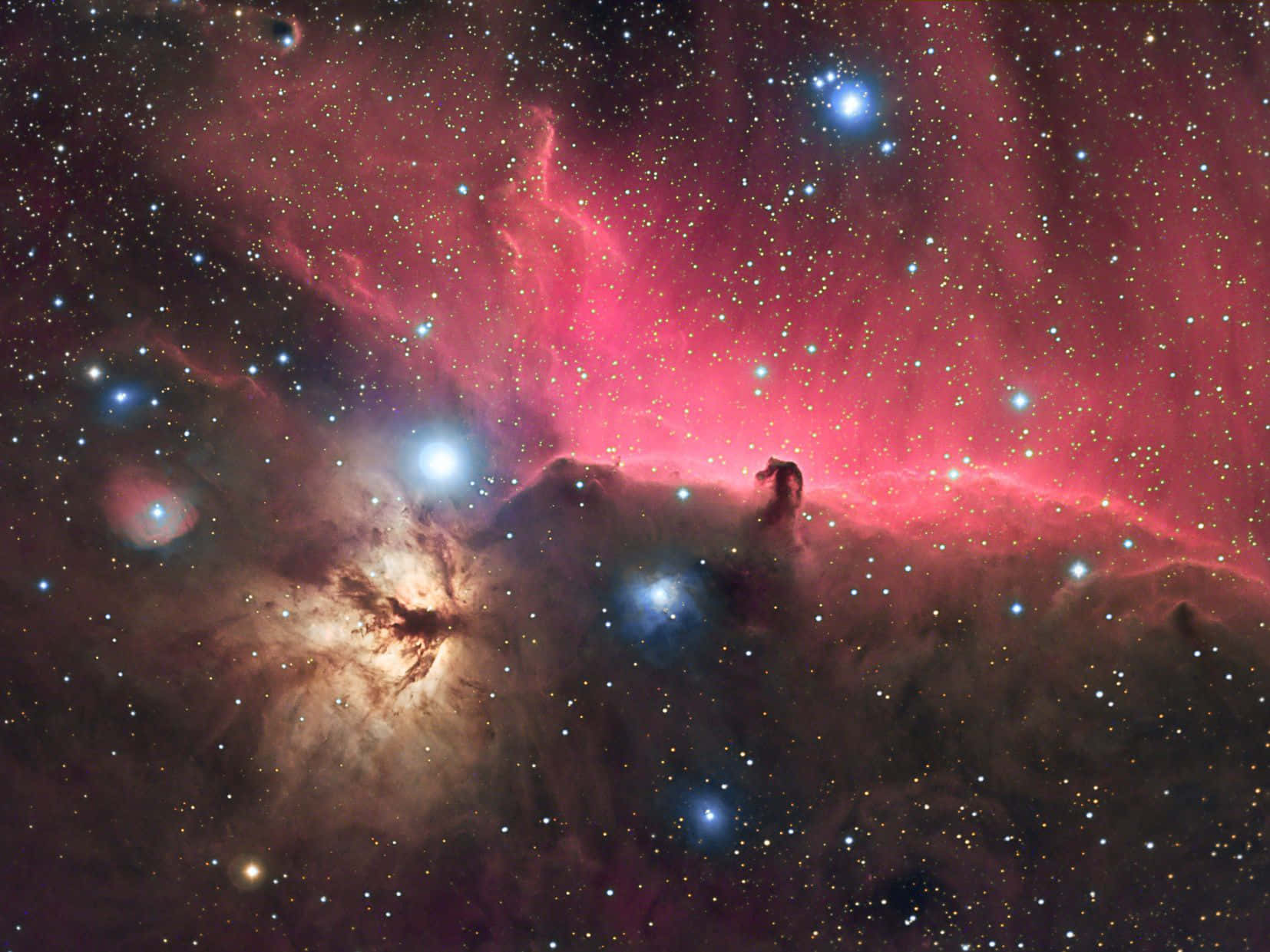 Horsehead Nebula 桌布 壁紙 — 獵戶座星雲在繁星點點的宇宙背景下散發出充滿活力的粉紅色和藍色色調，令人嘆為觀止。