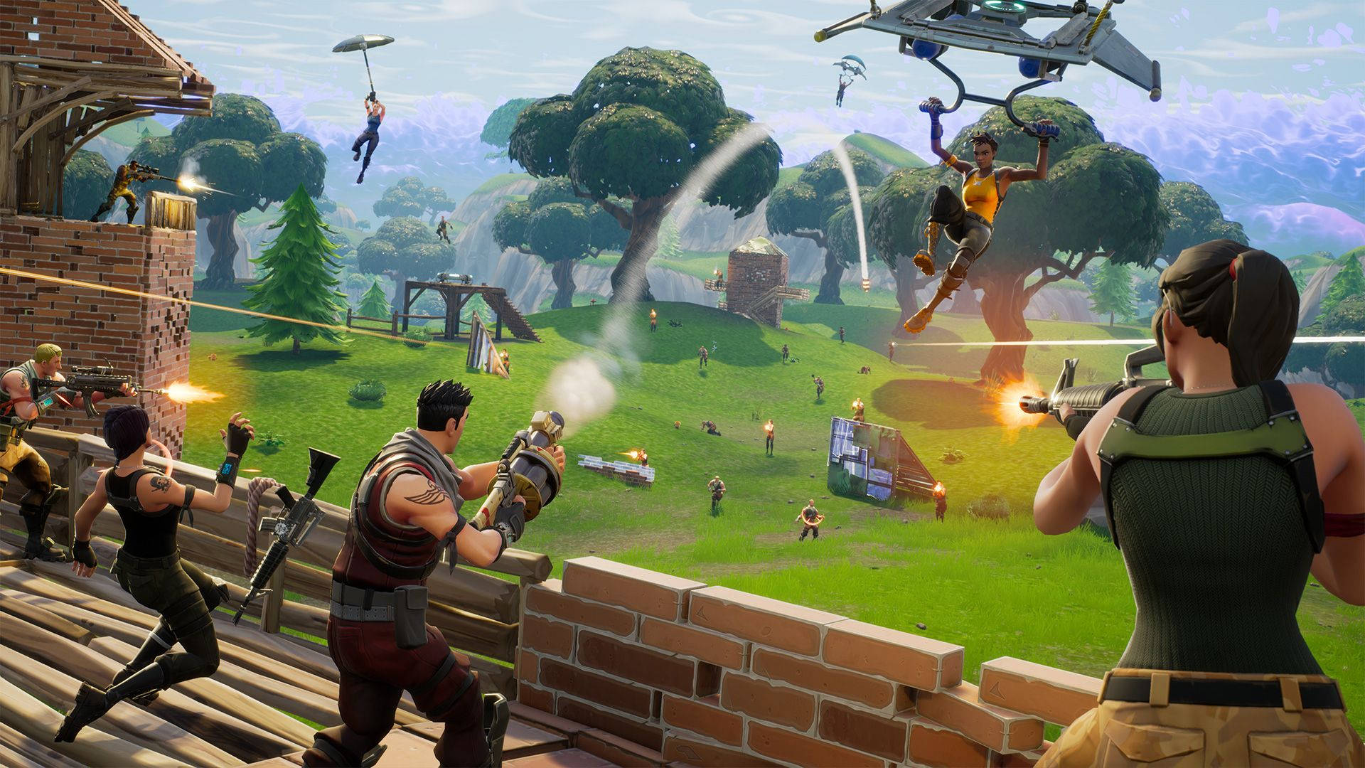 Fortnite 桌布 壁紙 — 玩家在一個有樹木和磚結構的草島上戰鬥，滑翔機在頭頂翱翔，構成一個充滿活力的Fortnite場景。