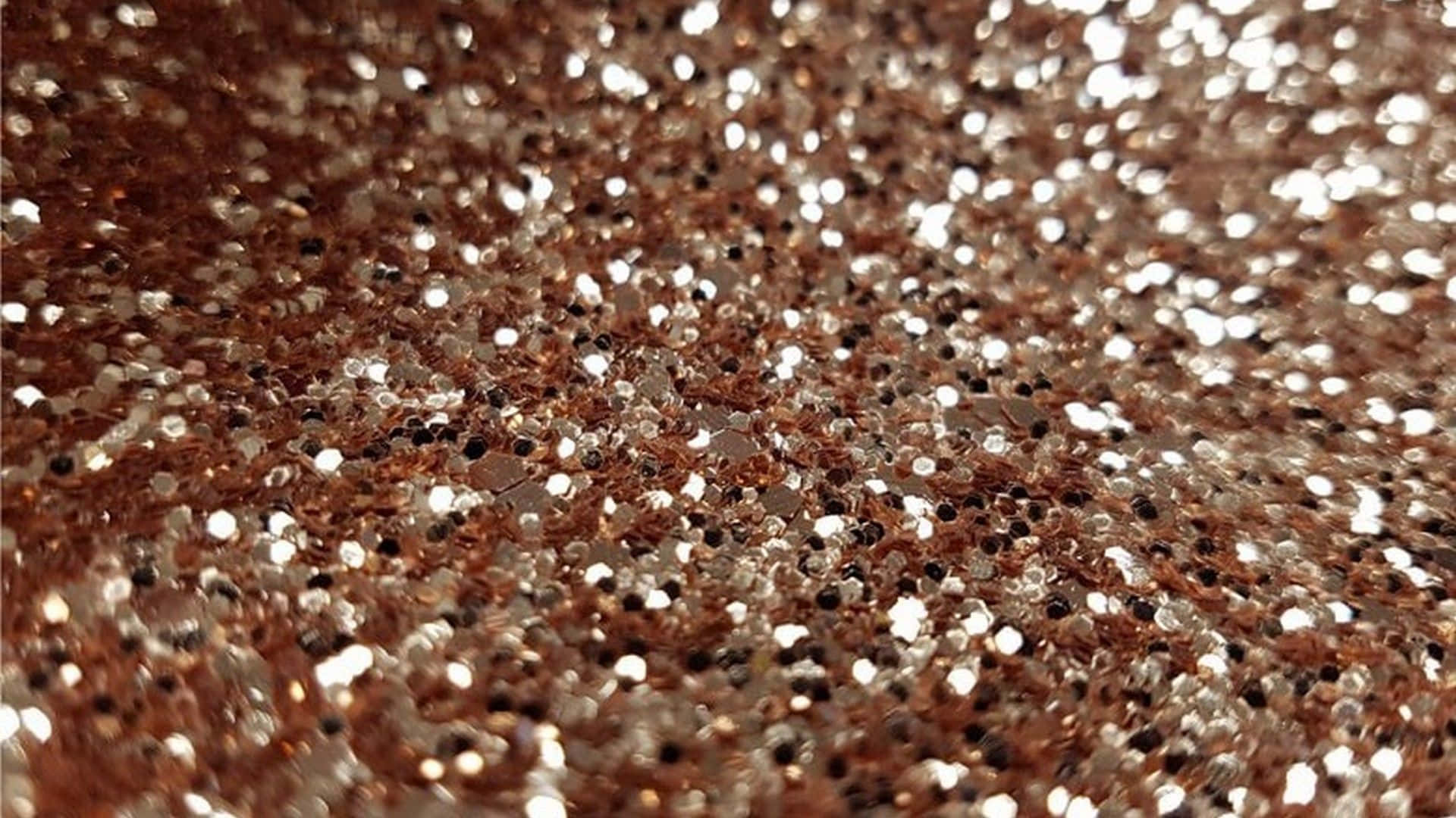Glitter Rose Gold 桌布 壁紙 — 玫瑰金和銀色亮粉顆粒在紋理閃光中捕捉光線的特寫。