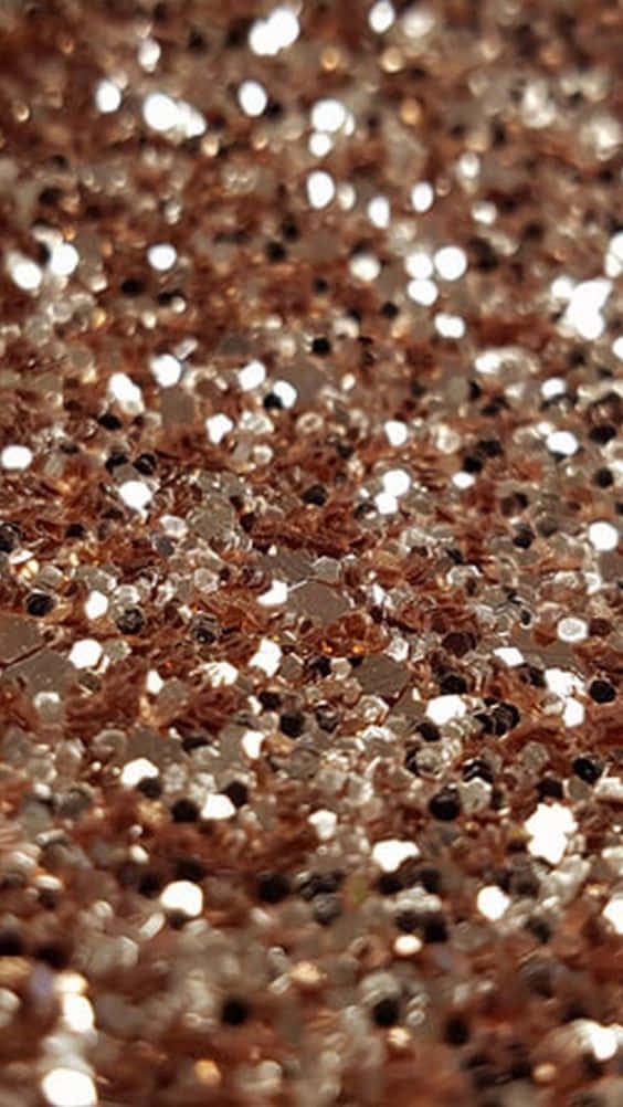 Rose Gold Color 桌布 壁紙 — 玫瑰金和銀色閃粉顆粒在紋理閃光中捕捉光線的特寫。