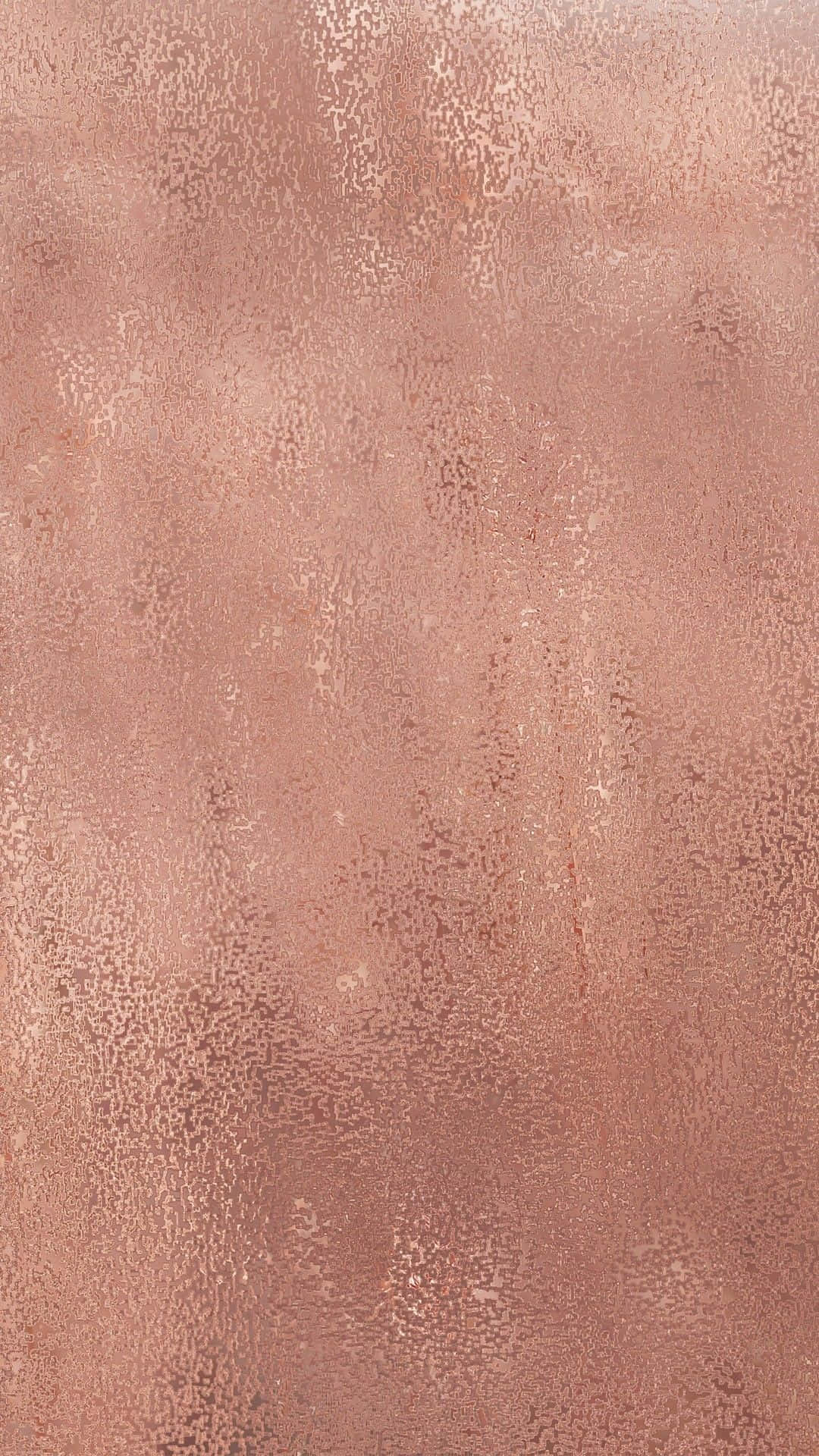 Rose Gold Color 桌布 壁紙 — 玫瑰金色金屬紋理表面的特寫，帶有細微斑點和柔和漸變燈光。