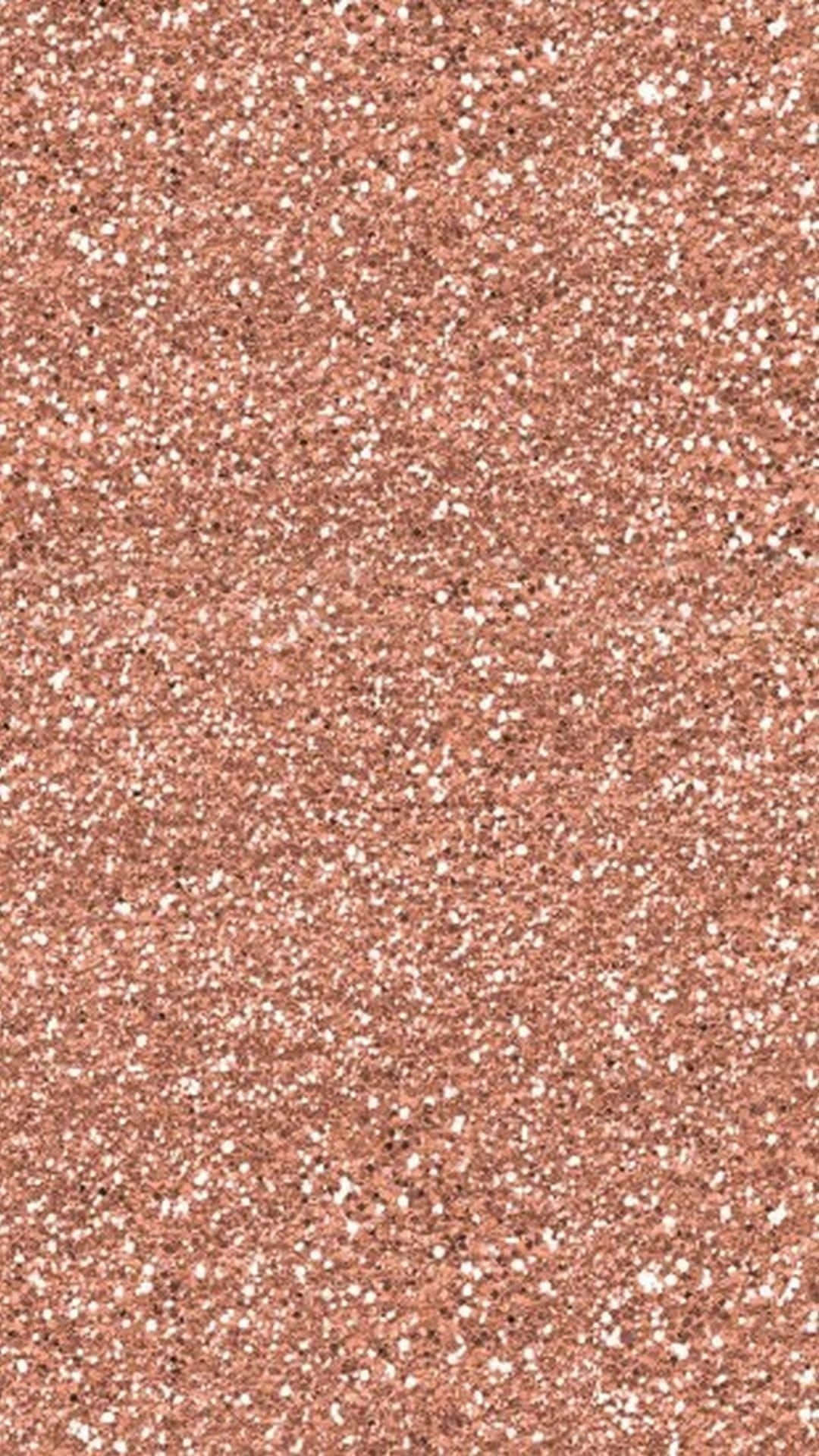 Glitter Rose Gold 桌布 壁紙 — 玫瑰金閃粉的特寫，帶有散落的白色斑點，營造出閃閃發光的紋理表面。