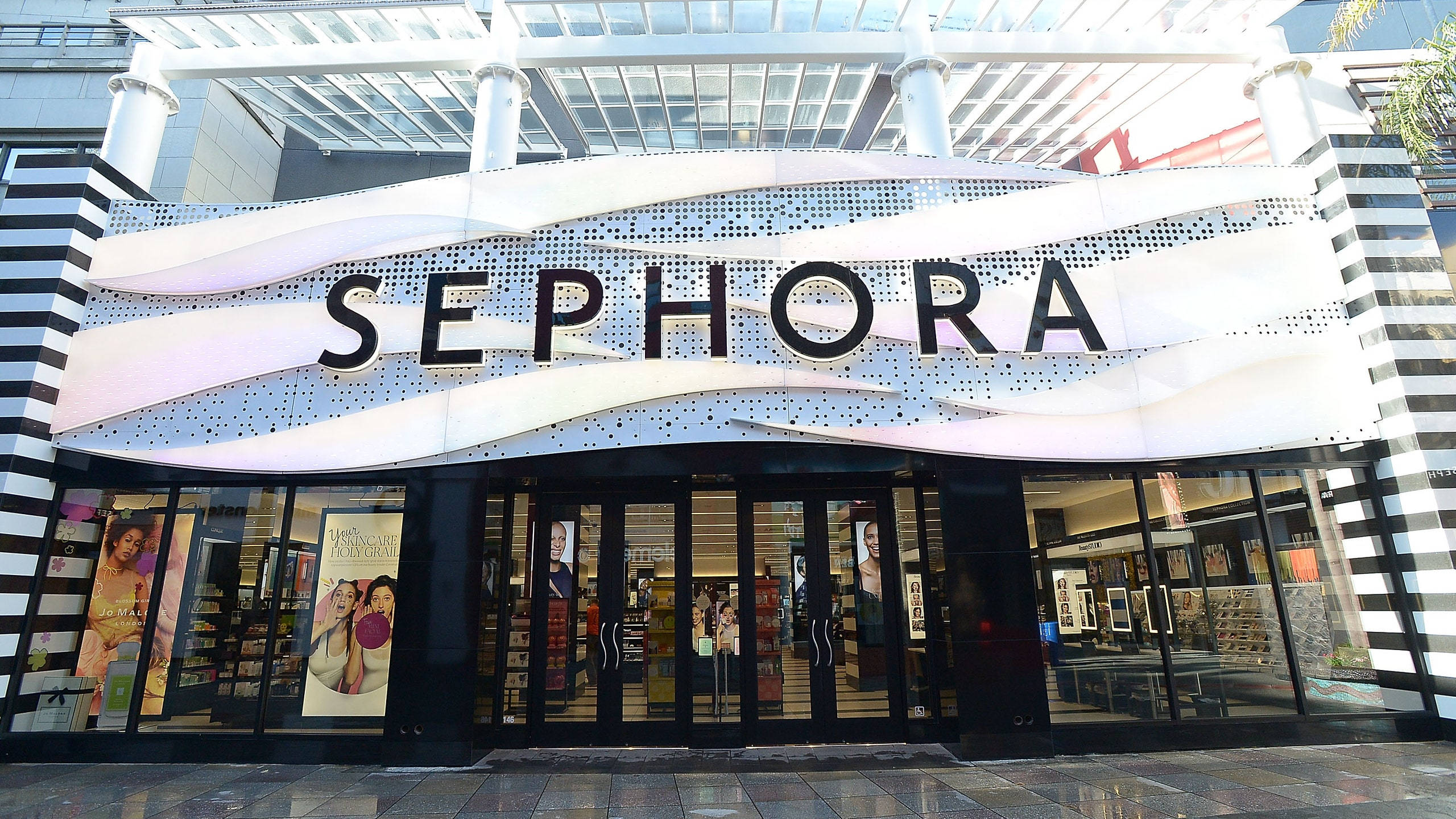 Sephora 桌布 壁紙 — 現代Sephora店鋪外牆，採用大膽的黑白條紋柱和玻璃簷篷下的弧形招牌。