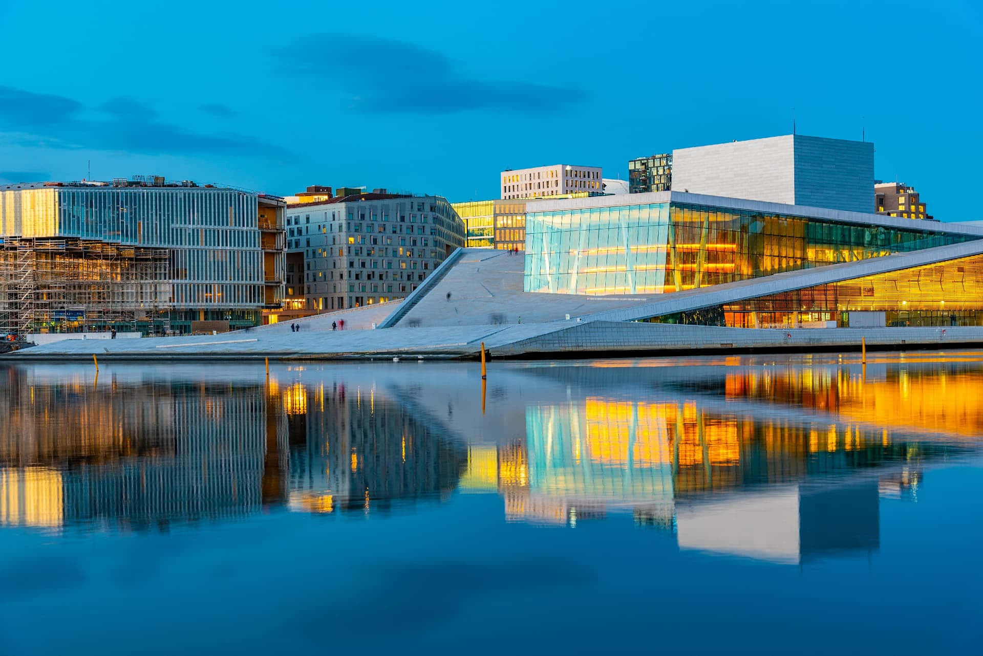 Norway 桌布 壁紙 — 現代奧斯陸歌劇院在暮色天空下，平靜水面上反射出金色光芒。