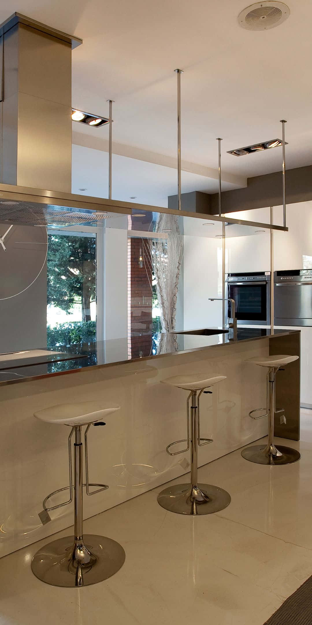 Pixel 3 Kitchen 桌布 壁紙 — 現代廚房，配備時尚玻璃和鉻合金吧檯凳，下方有明亮的嵌入式照明。