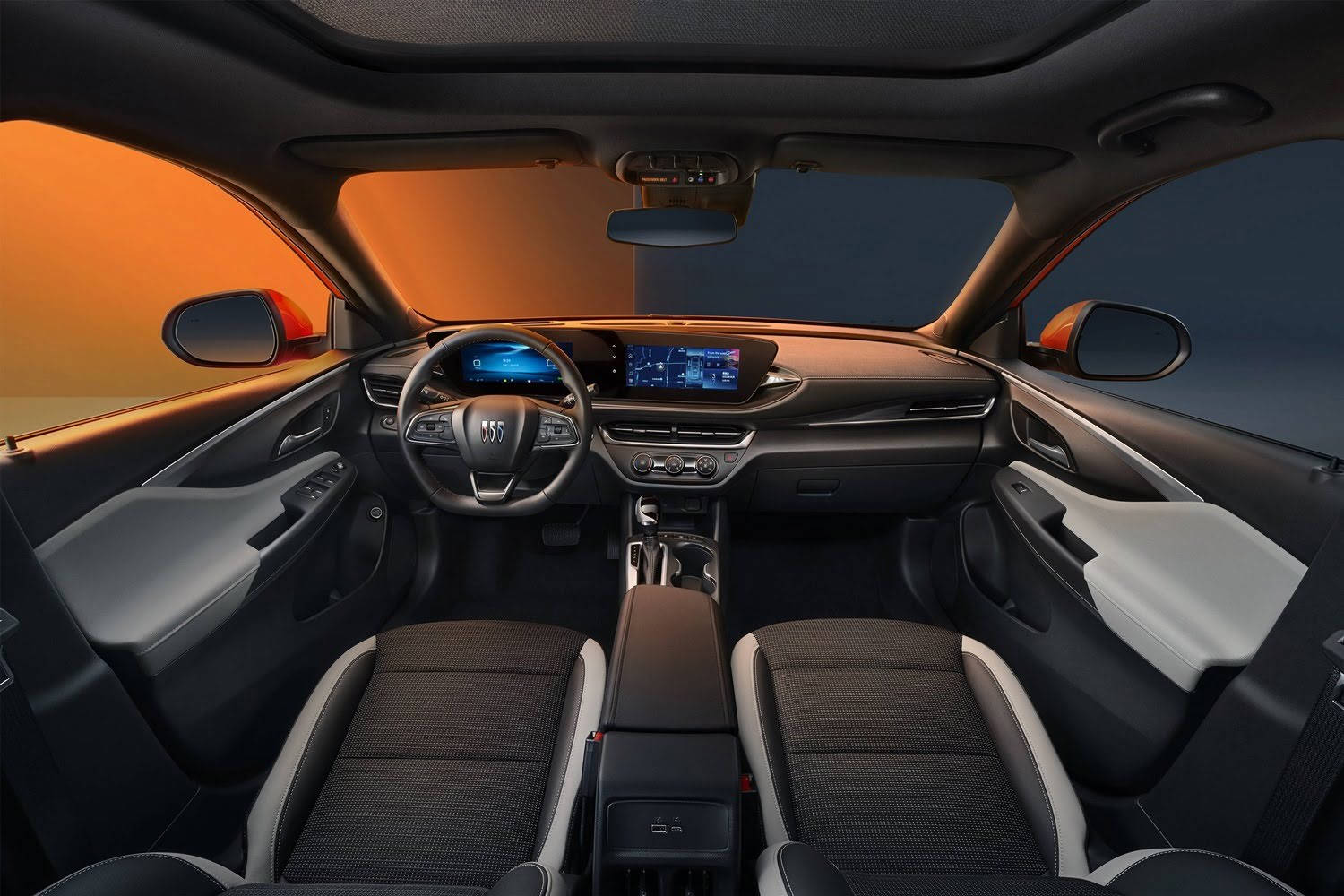 Buick 桌布 壁紙 — 現代汽車內飾，配備黑色和灰色座椅，在漸變日落背景下由溫暖的橙色環境照明照亮。