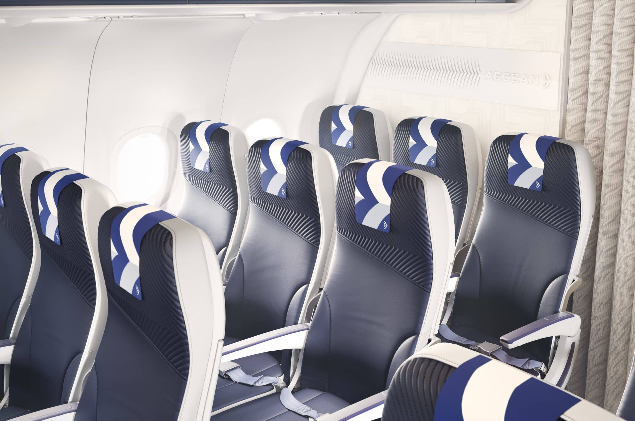 Plane 桌布 壁紙 — 現代飛機艙內一排排時尚的藍白飛機座椅，帶有航空公司標誌的頭枕。