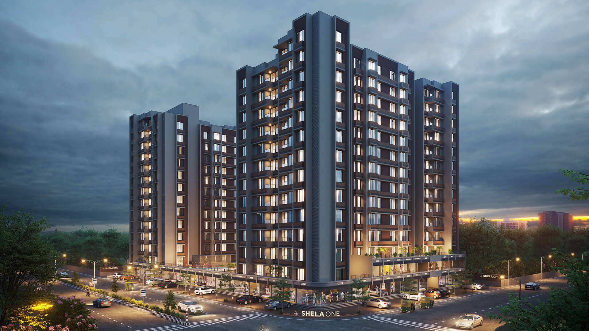 Ahmedabad 桌布 壁紙 — 現代高層住宅大樓在暮色蒼茫的天空下溫暖地發光，下方有街燈和汽車。