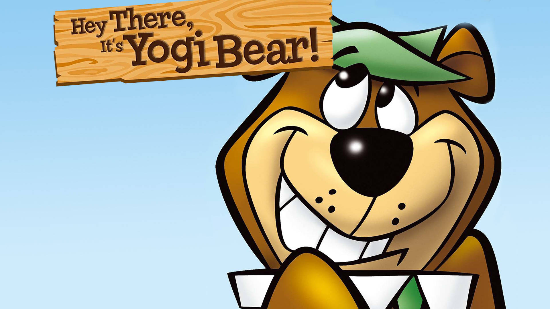 Yogi 桌布 壁紙 — 瑜伽熊在卡通插圖中愉快地微笑，手持一個寫著 Hey There It's Yogi Bear! 的木牌。