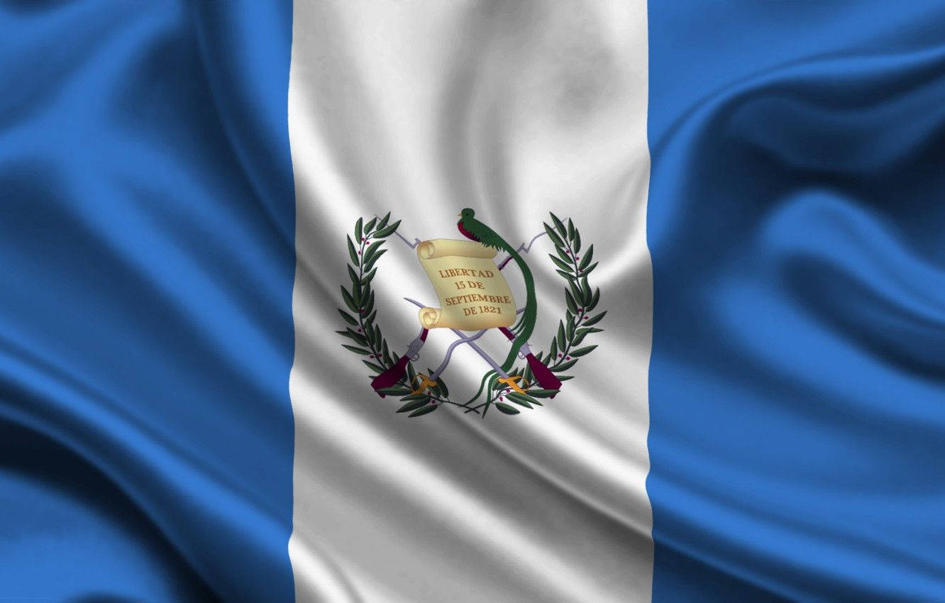 Guatemala 桌布 壁紙 — 瓜地馬拉國旗動態飄揚，帶有深藍色和純白色條紋，中央有包含格查爾鳥和卷軸的國徽。