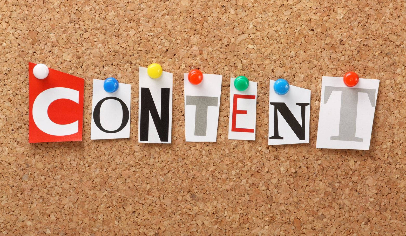 Idea 桌布 壁紙 — 用彩色紙字母拼出的「content」一詞釘在軟木板上。