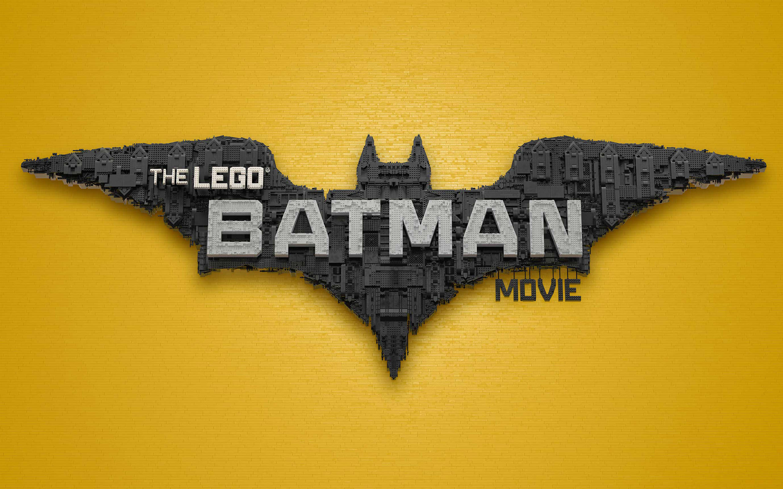 Batman Logo 桌布 壁紙 — 由黑色LEGO積木製成的LEGO蝙蝠俠電影標誌，在充滿活力的黃色紋理背景上大膽突出。