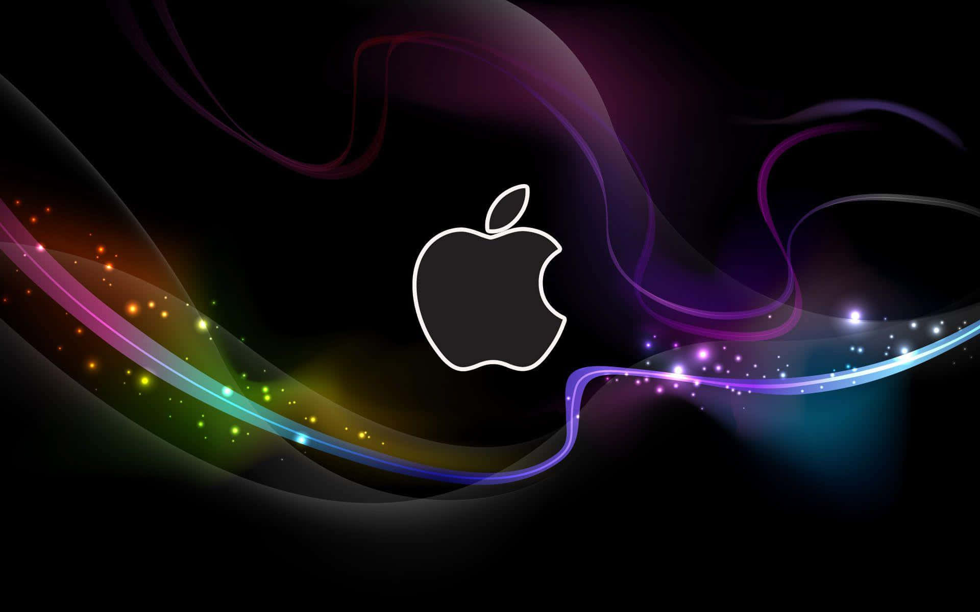 桌布 壁紙 — 發光的Apple標誌置於深色背景中央，伴隨旋轉的彩虹光跡和閃爍粒子。
