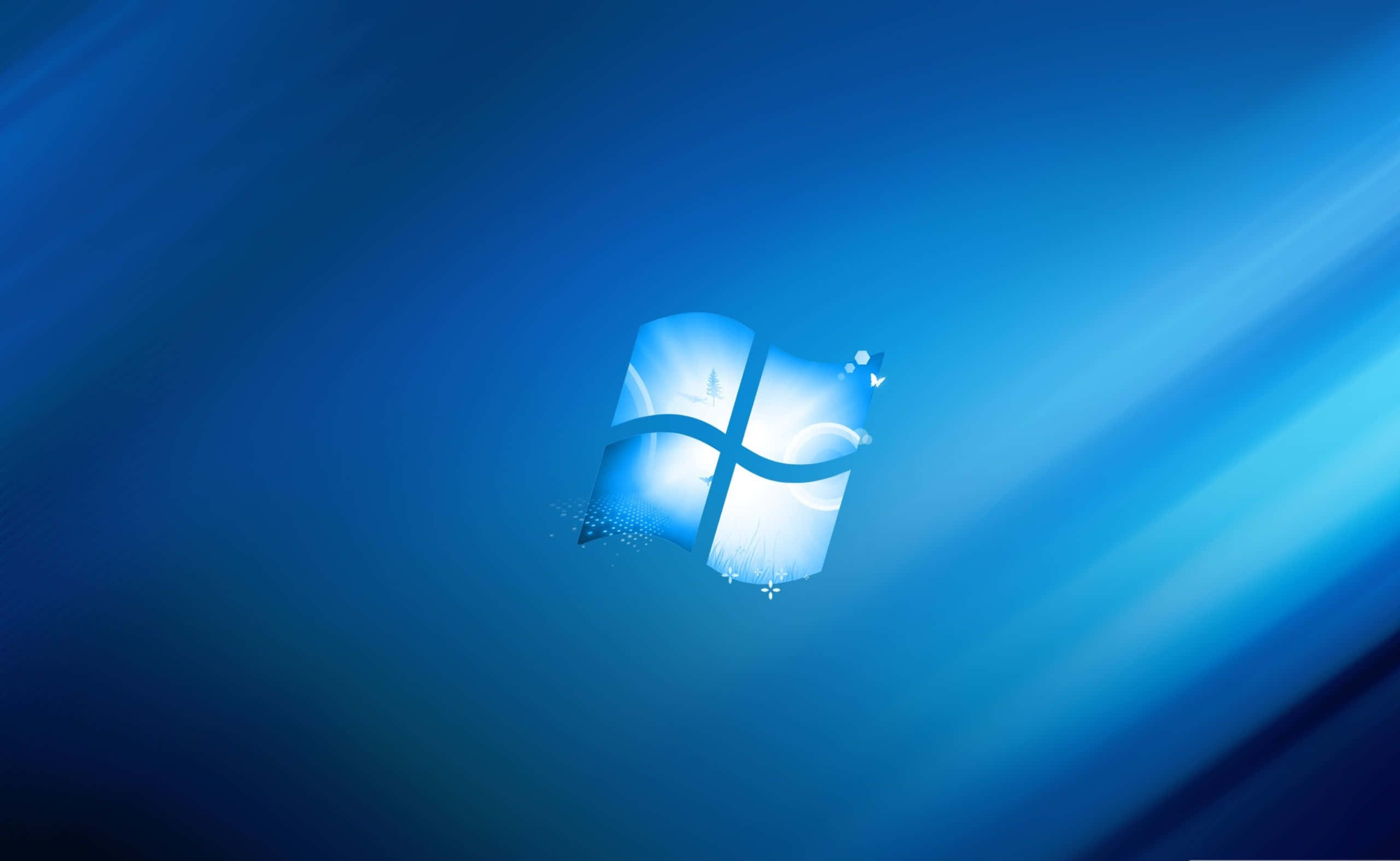 Windows Logo 桌布 壁紙 — 發光的Windows標誌居中於漸變藍色背景上，帶有向外輻射的光線條紋。