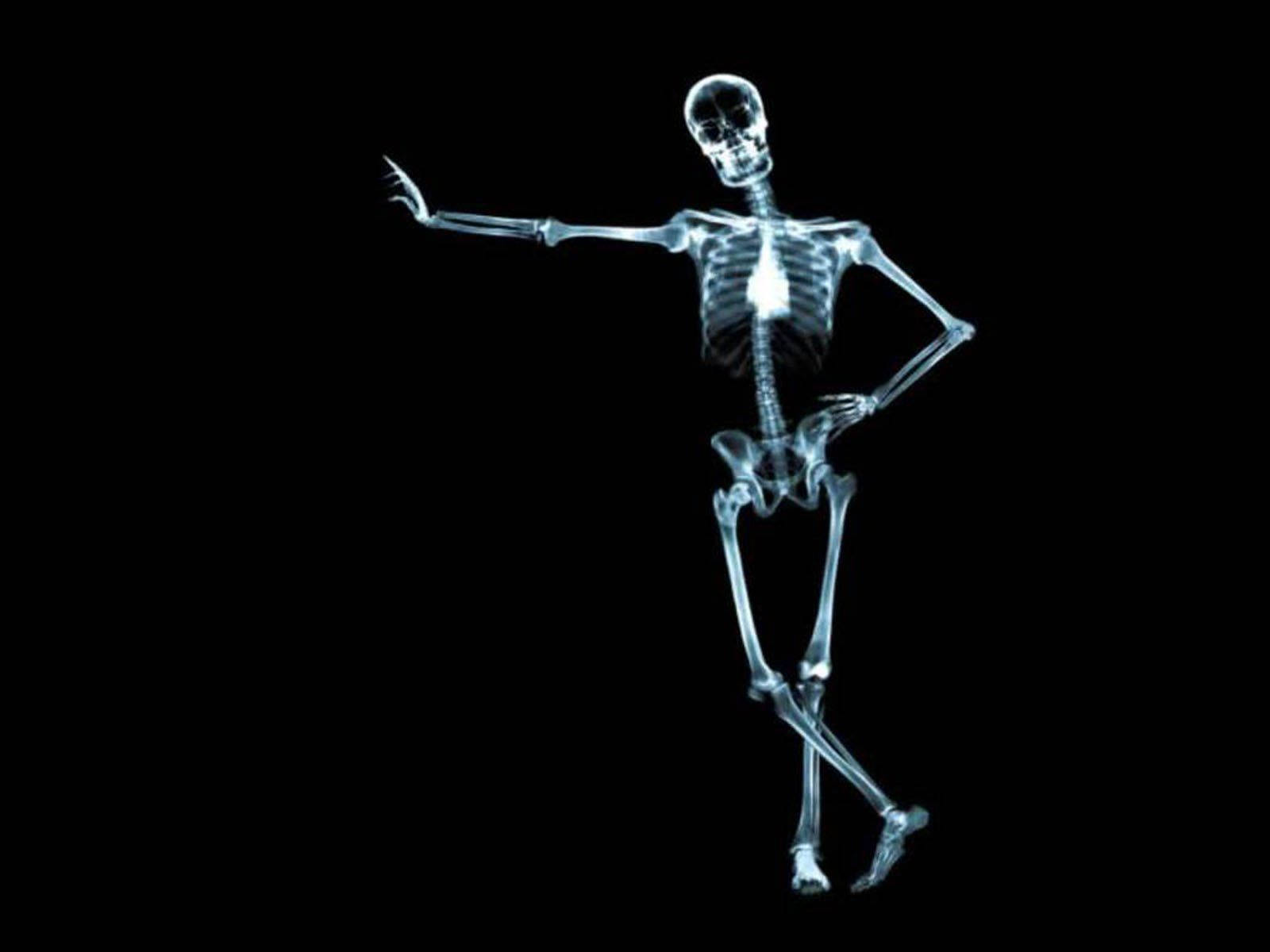 Cute Skeleton 桌布 壁紙 — 發光的X光骨架在純黑背景上擺出動感舞蹈姿勢。