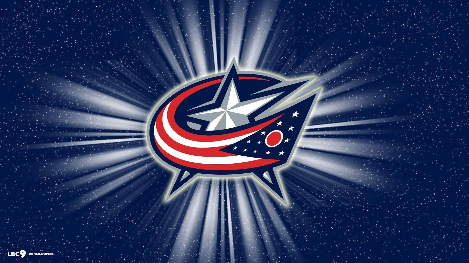 Columbus Blue Jackets 桌布 壁紙 — 發光的哥倫布藍夾克標誌在繁星點點的深藍色背景上放射出明亮的光芒。