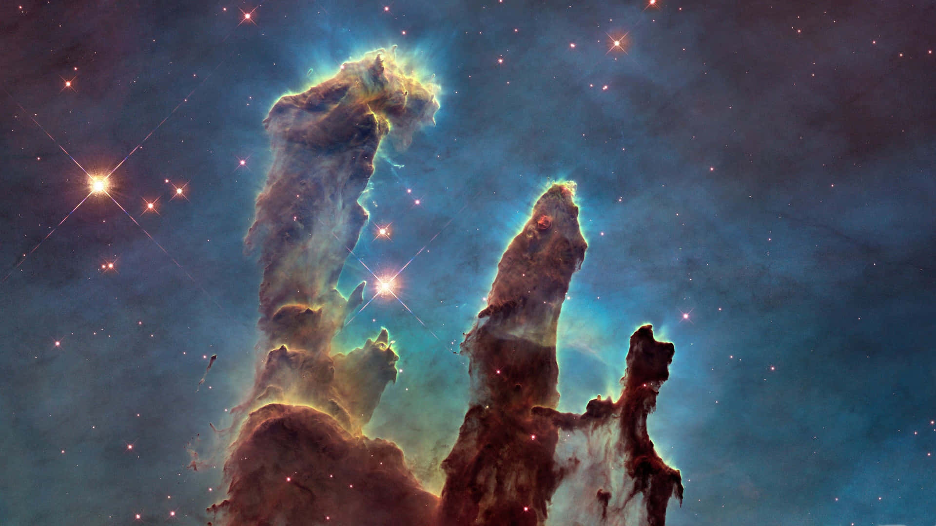 在充滿星星的星雲中，宇宙柱散發著藍色和橙色的色調。 — 星雲 GIF 壁紙