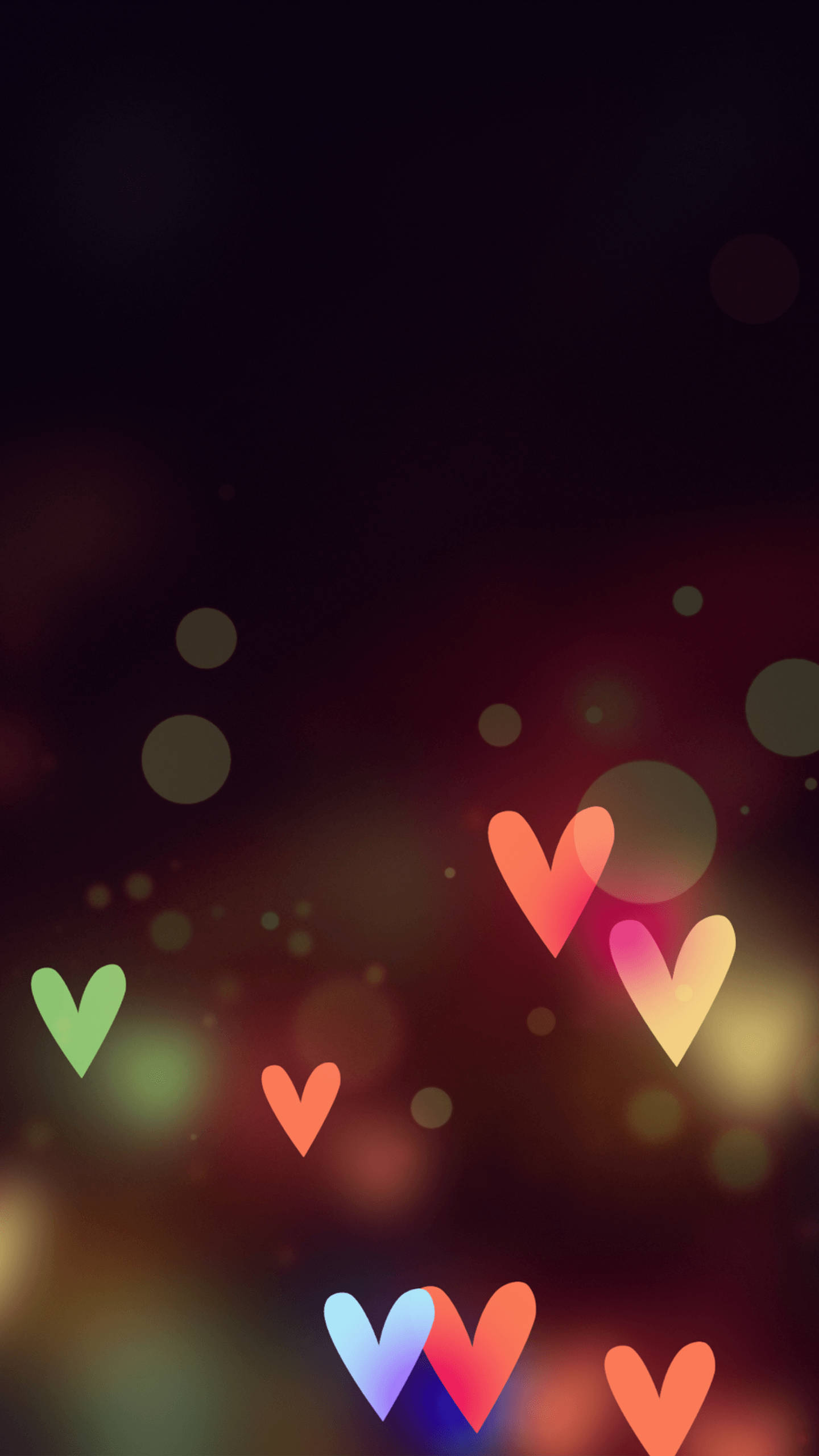 Love iPhone 桌布 壁紙 — 發光的彩色心形在黑暗模糊的背景上漂浮，帶有柔和的散景燈光。