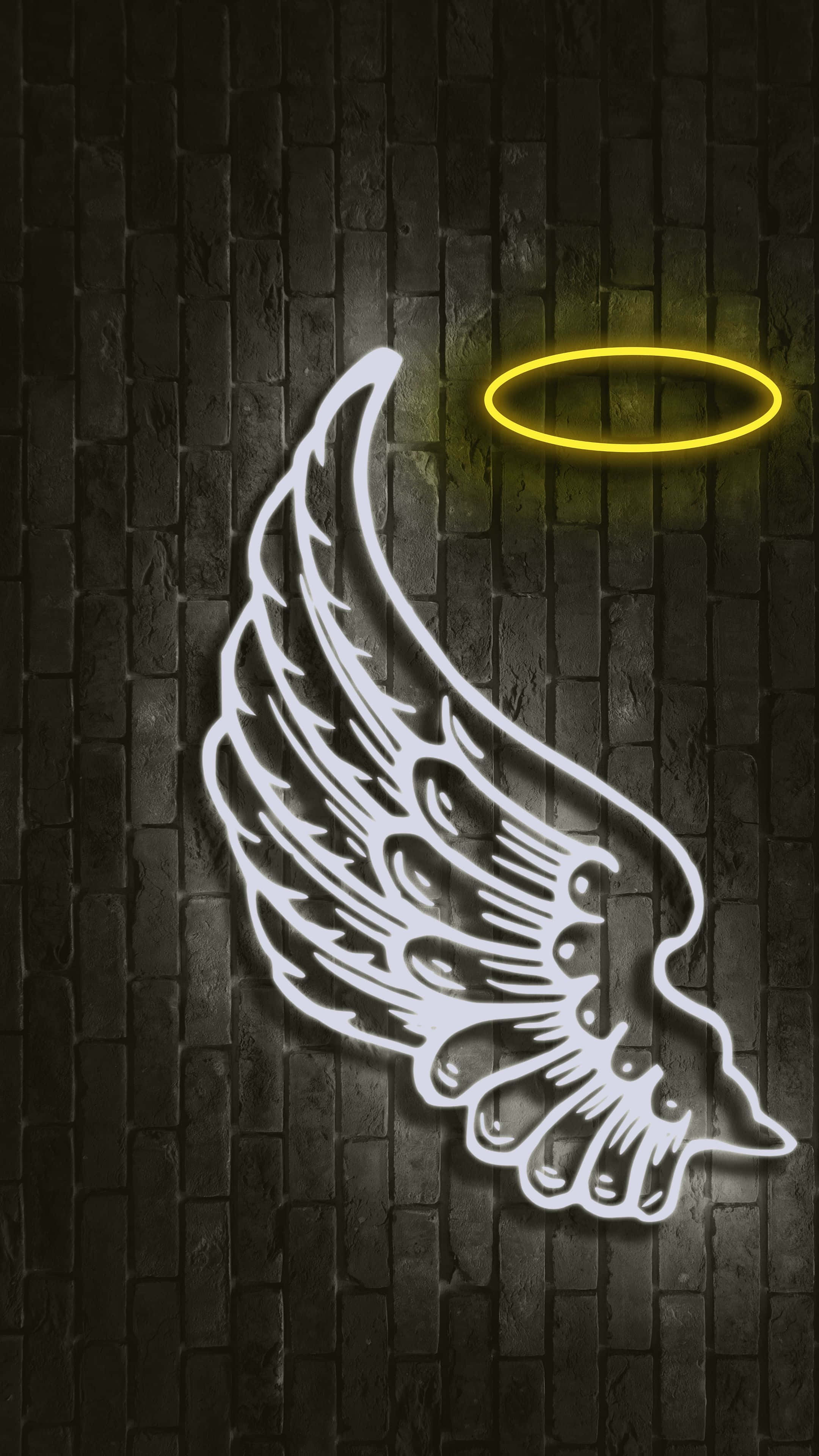 Angel Wings 桌布 壁紙 — 發光的白色霓虹天使翅膀和光環照亮了深色磚牆，帶有溫暖的黃色光芒。