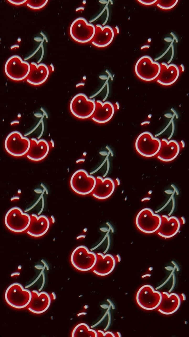 Retro 桌布 壁紙 — 發光的紅色櫻桃帶有白色輪廓和綠色莖，在深色斑點背景上重複。