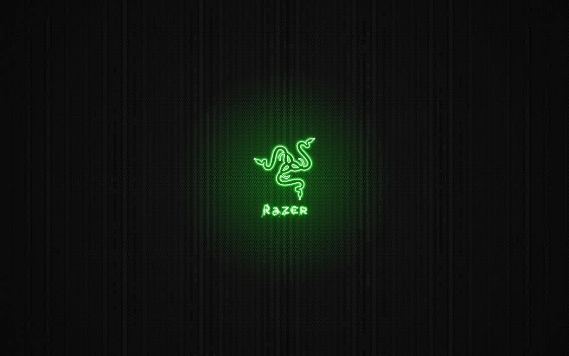 雷蛇 桌布 壁紙 — 發光的綠色Razer標誌在深色紋理背景上柔和地脈動。